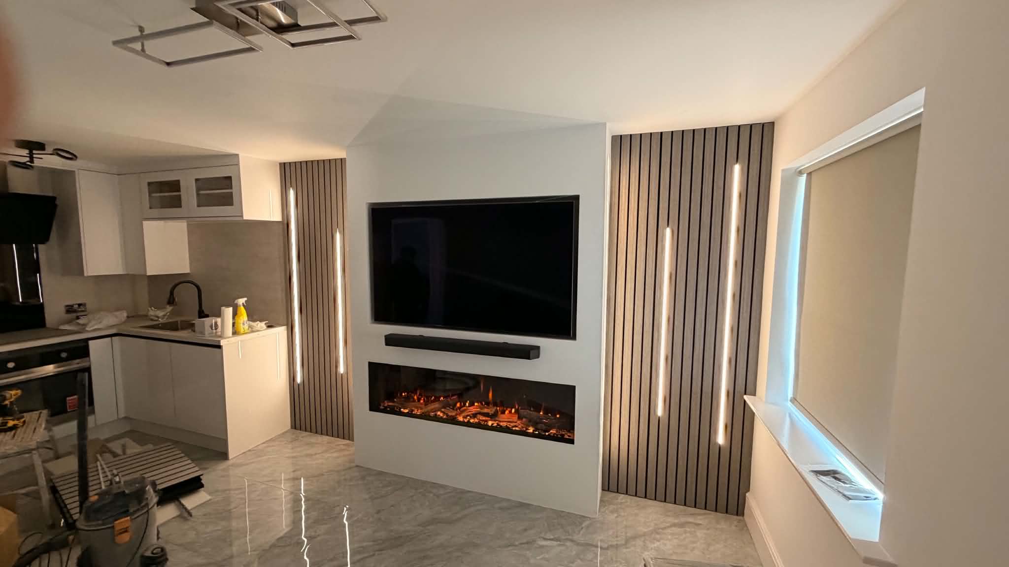 Media wall with three-sided electric fire and recessed display shelves