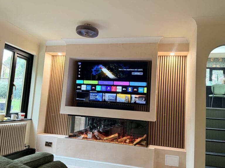 Bespoke grey media wall with electric fire, floating shelves and TV in a Sheffield living room
