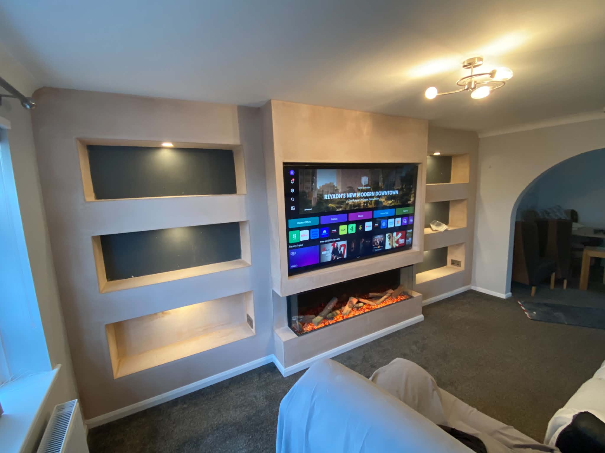 White media wall with long electric fire and floating shelves