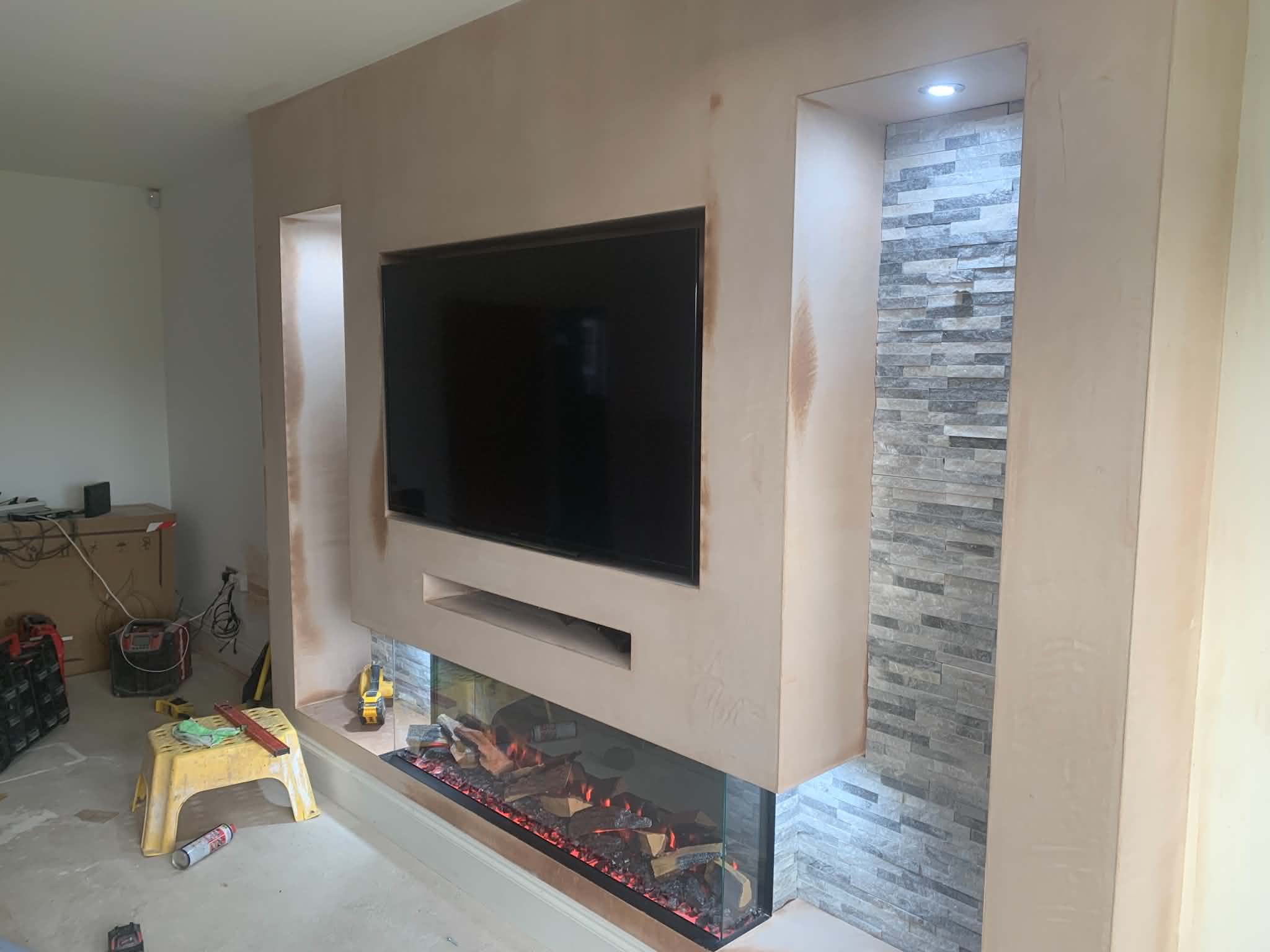 Bright media wall with recessed TV and oak slatted feature panel